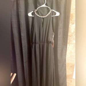 Black dress with rhinestones around the neck.